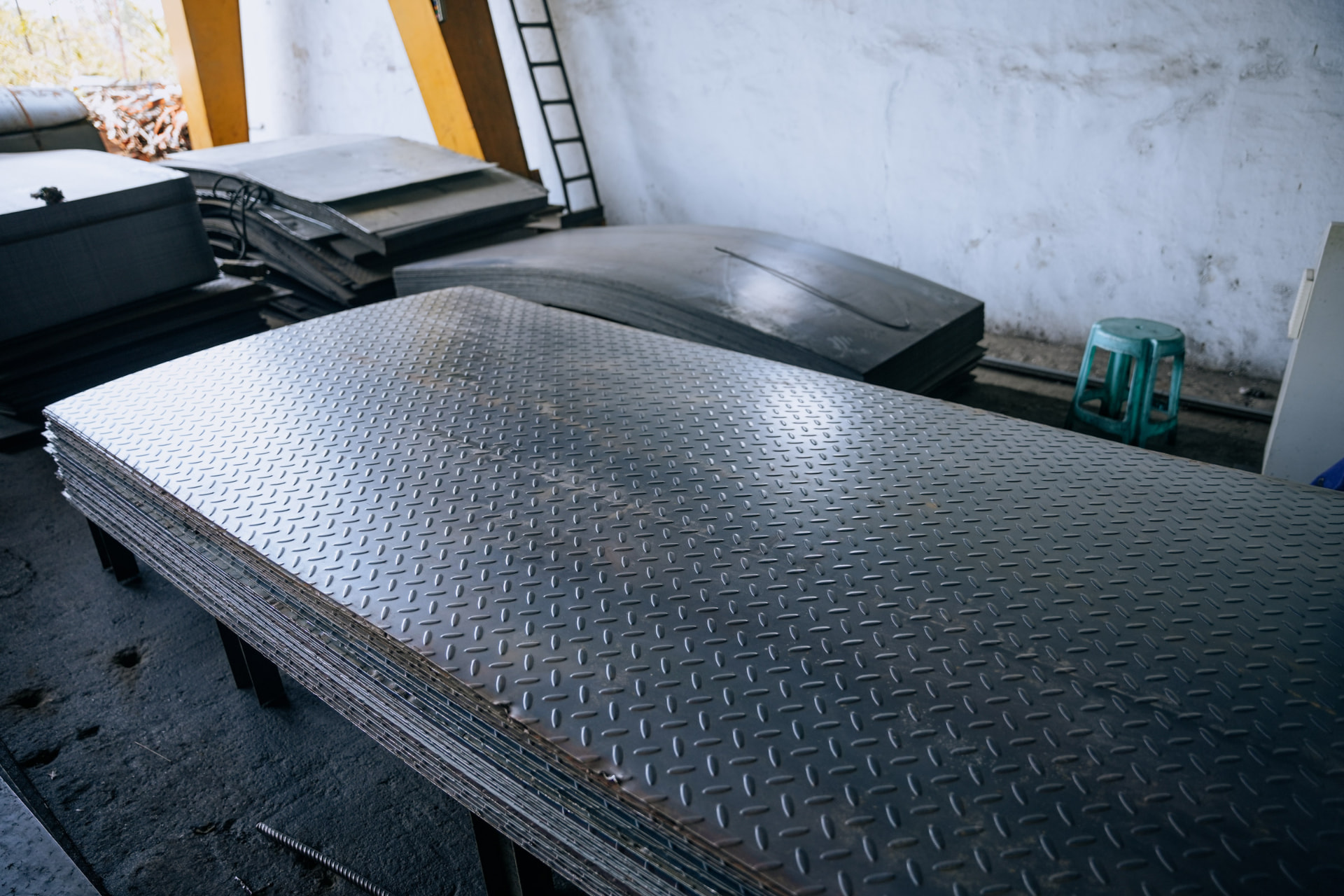 Stack of MS chequered plates with diamond tread pattern at the HST Steels facility
