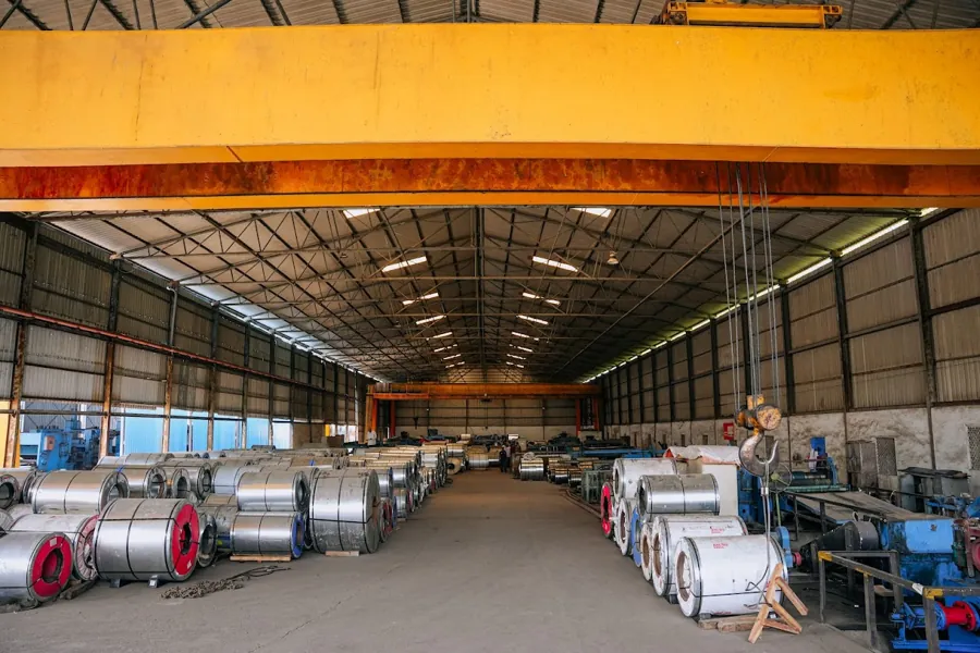 HST Steels warehouse with overhead gantry crane and steel inventory in Hyderabad